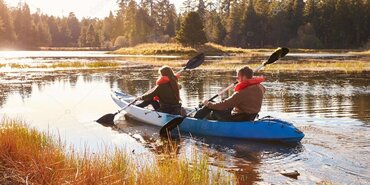 Couple kayaking on lake