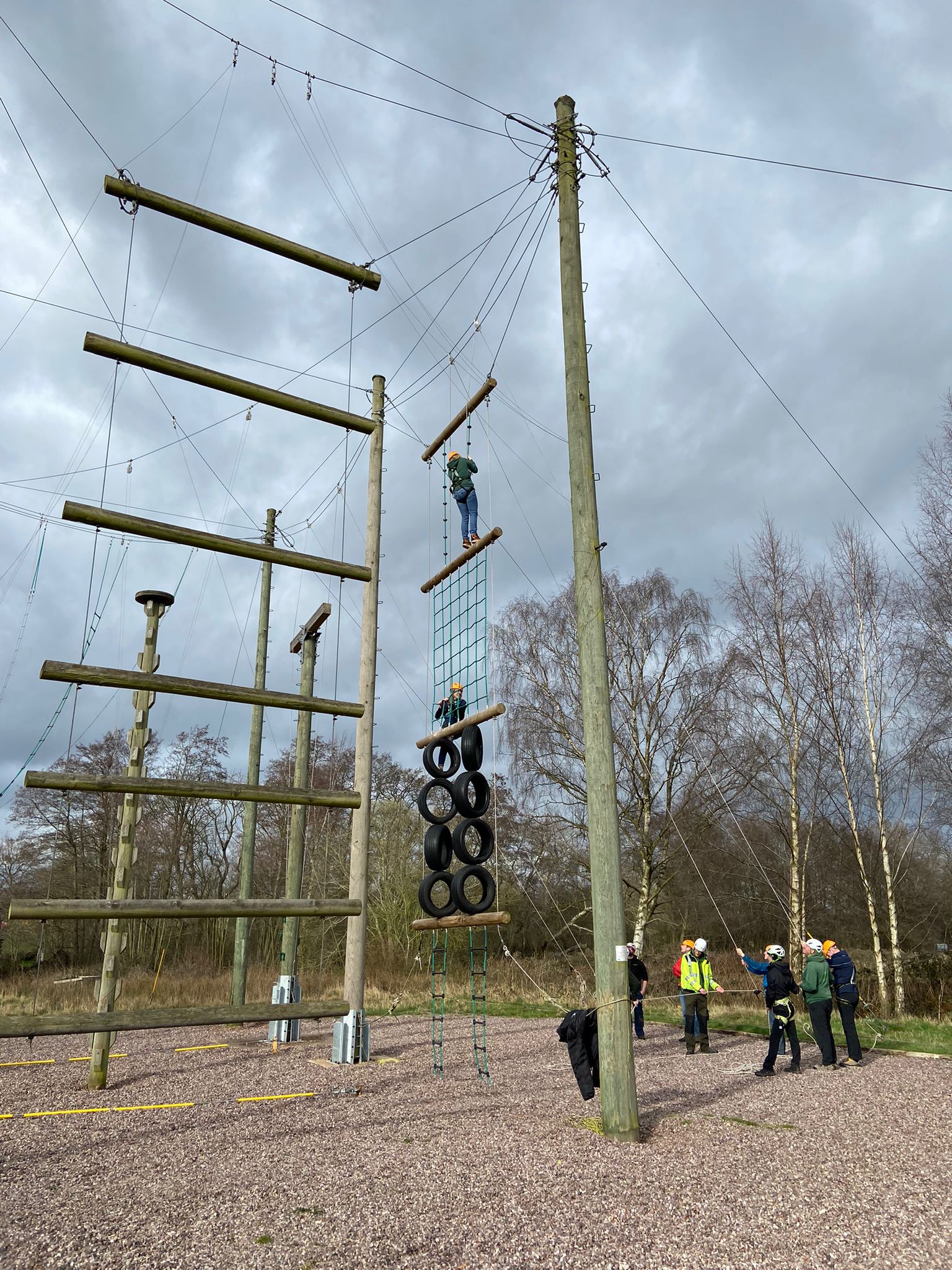Adventure center rope rigging with people climbing